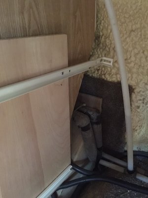This image shows shortened drawer glides and support board installed to hold the glides.  Here you can also see how cabinet was cut around obstacles.