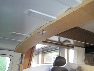 Attached to the plywood and over the metal roof rib